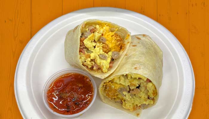 Breakfast burrito in hand and served at Taco Shop Mexican restaurant in Fargo, ND